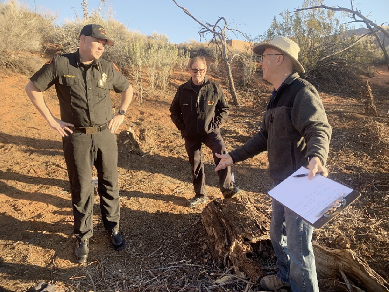 Chuck Warren, right, reviews Tamarisk removal procedures with Santa Clara-Ivins Fire& Rescue Chief Andrew Parker, left, and Battalion Chief Con Fulde, center.