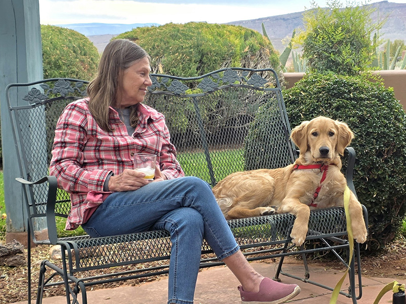 Barb relaxing in her garden with Max, the latest in 50 years of beloved dogs