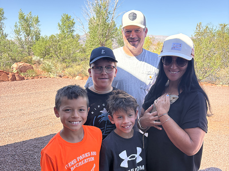 Adoptive family with thier new pet bearded Dragon, Mango